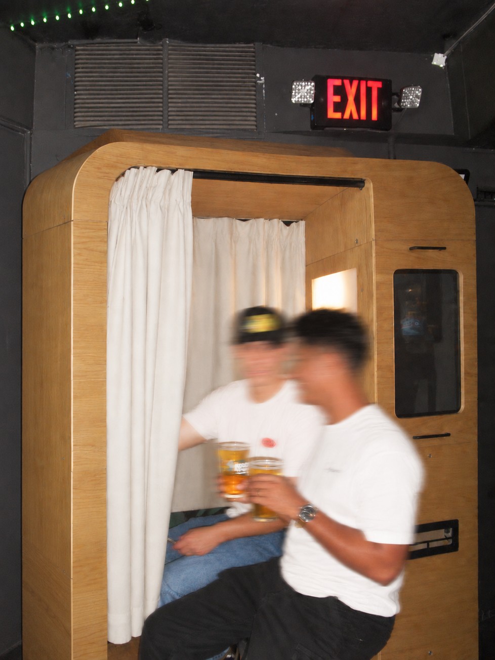 Guests sharing a moment outside an enclosed photo booth