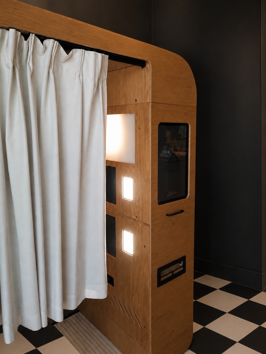 Wooden enclosed photo booth with a white curtain